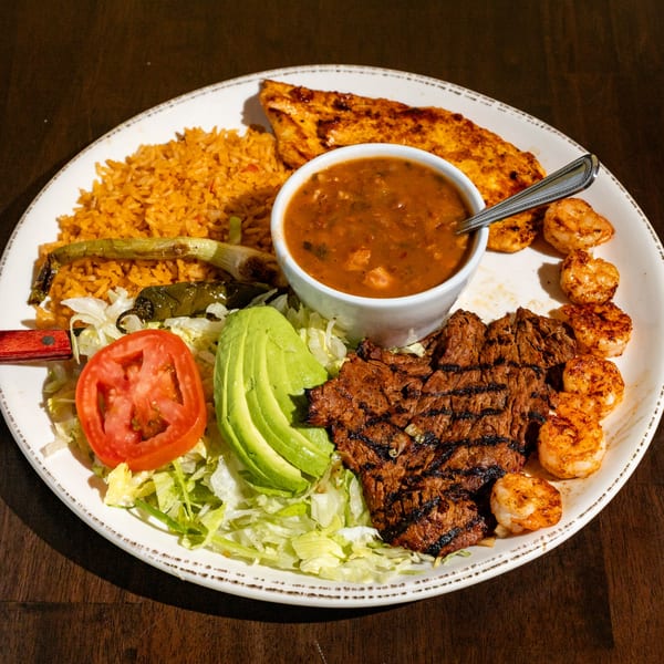 Chuyita's Mexican Restaurant's grilled steak, shrimp, chicken, rice, beans, avocado, and salad.